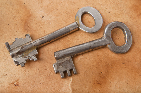 the old keys on the background of the old paper