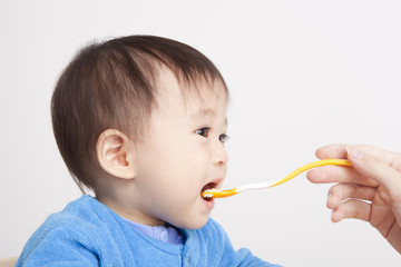 Baby eating with spoon