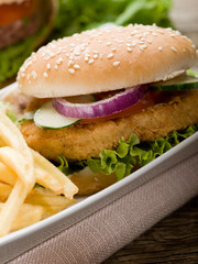 sandwich hamburger with chicken  potatoes and salad