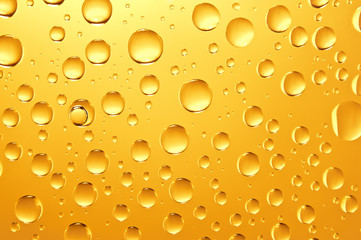 background of golden water big and small drops