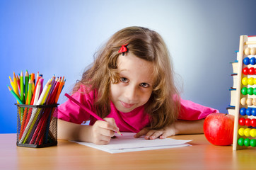 Little girl drawing with pencils