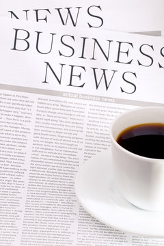Business newspaper and  cup of coffee
