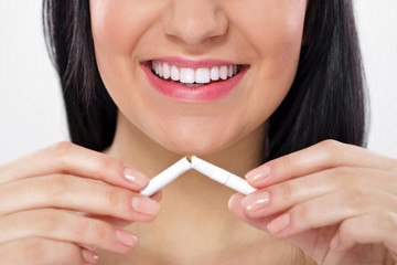 woman breaking cigarette