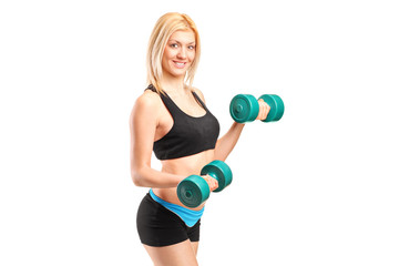 Fototapeta premium An attractive woman lifting up weights