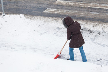 Woman shoveling snow
