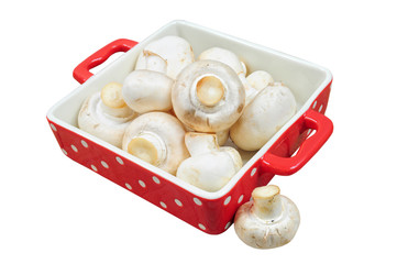 Fresh mushrooms in red tray, isolated