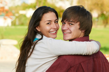 Two smiling young students outdoors