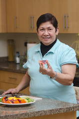 Senior asian filipino woman preparing food