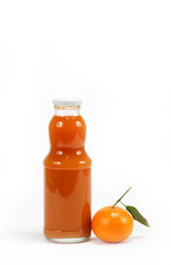 Juice in a glass bottle and tropical fruit on a white background