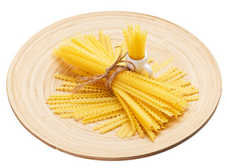 Pasta bunch composition on a wooden plate, isolated on white