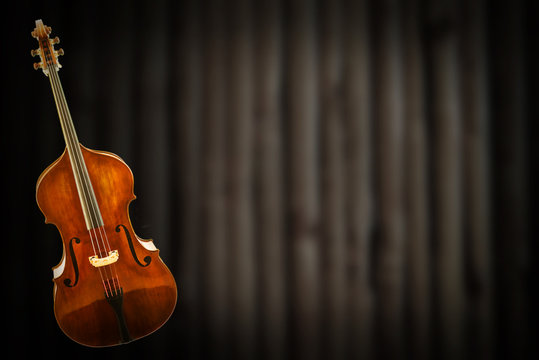 Old violin on vintage background