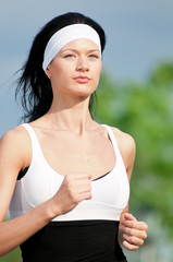 Woman running in green park