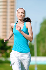 Beautiful woman running in green park