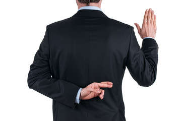 young businessman in suit telling a lie with the fingers crossed