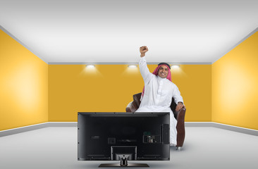 arabian man watching TV in an interior