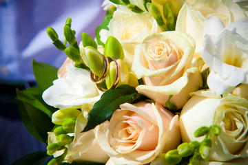 rings on white wedding flowers.