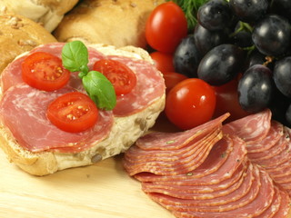 Sandwich with slices of salami and tomatoes