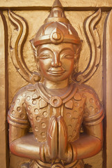 Thai statues on the temple wall.