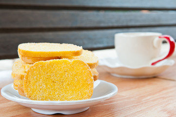 Buttered bread with cup of coffee