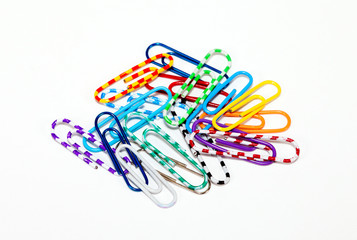 Сolorful paper clips on white background.
