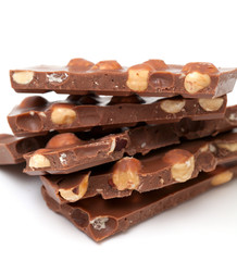 milk chocolate with hazelnuts isolated on white