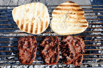 grilled pork sausage and roasted bread on a barbecue