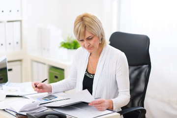 Mature business woman working at office