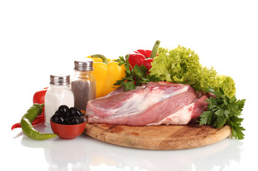 Raw meat and vegetables on a wooden board isolated on whitе