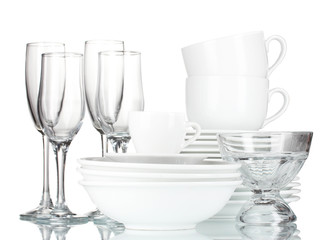 empty bowls, plates, cups and glasses on grey background