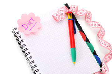 Planning of diet. Notebook measuring tape and pencil isolated