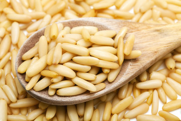 pine nuts in a wooden spoon