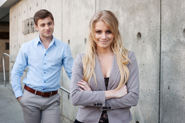 portrait of a young businesswoman with businessman in background