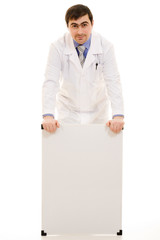 Male doctor with a white board on a white background.