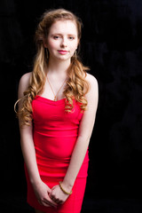 attractive young girl wearing red dress on black