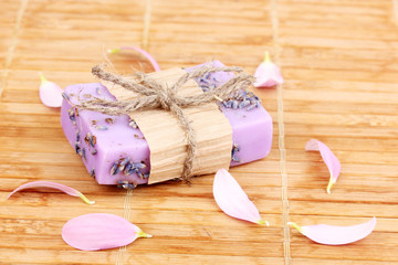 Hand-made lavender soap on wooden mat