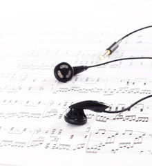 Ear phone on the top of a music sheet