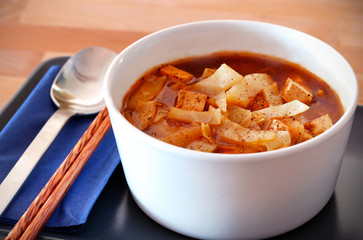 Hot and sour chinese cabbage soup in a white bowl