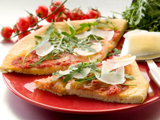 Pizza with arugula and parmesan cheese
