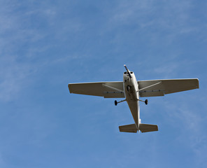 Small fixed wing plane against a clear blue sky