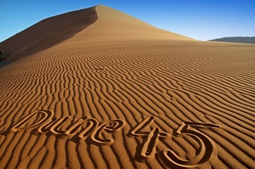 Naklejka premium Dune 45 with written name of Dune 45 in the sand, Namibia
