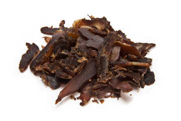 Sliced biltong (dried beef) on a white background.