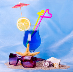 Exotic cocktail with tropical shell and glasses