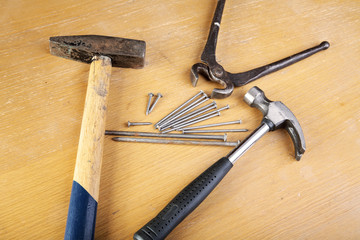 Two hammers and pincers with nails