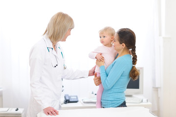 Young mother with baby visiting pediatric doctor © Alliance