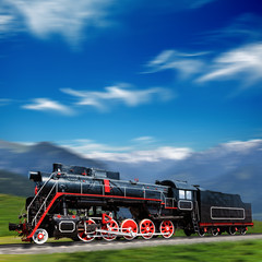 Speeding old locomotive in mountains with motion blur