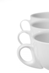 Row of Three Coffee Cups on White Background.