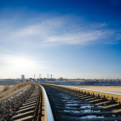 railroad to horizon under deep blue sky in sunset