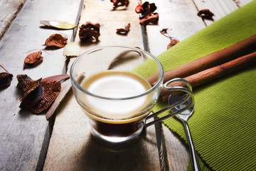 A cup of coffee on wood background