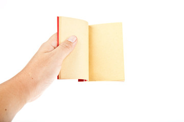 Obraz premium Red book open with hand isolated on white background