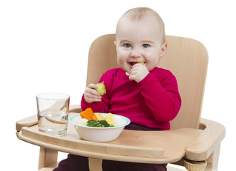 young child eating in high chair